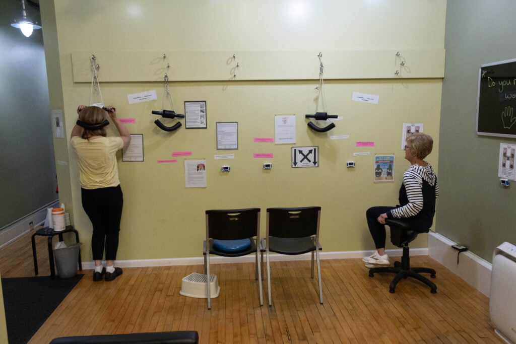 Patient performing a guided corrective exercise with Dr. Kelly at Tree of Life Wellness Center in Elmhurst